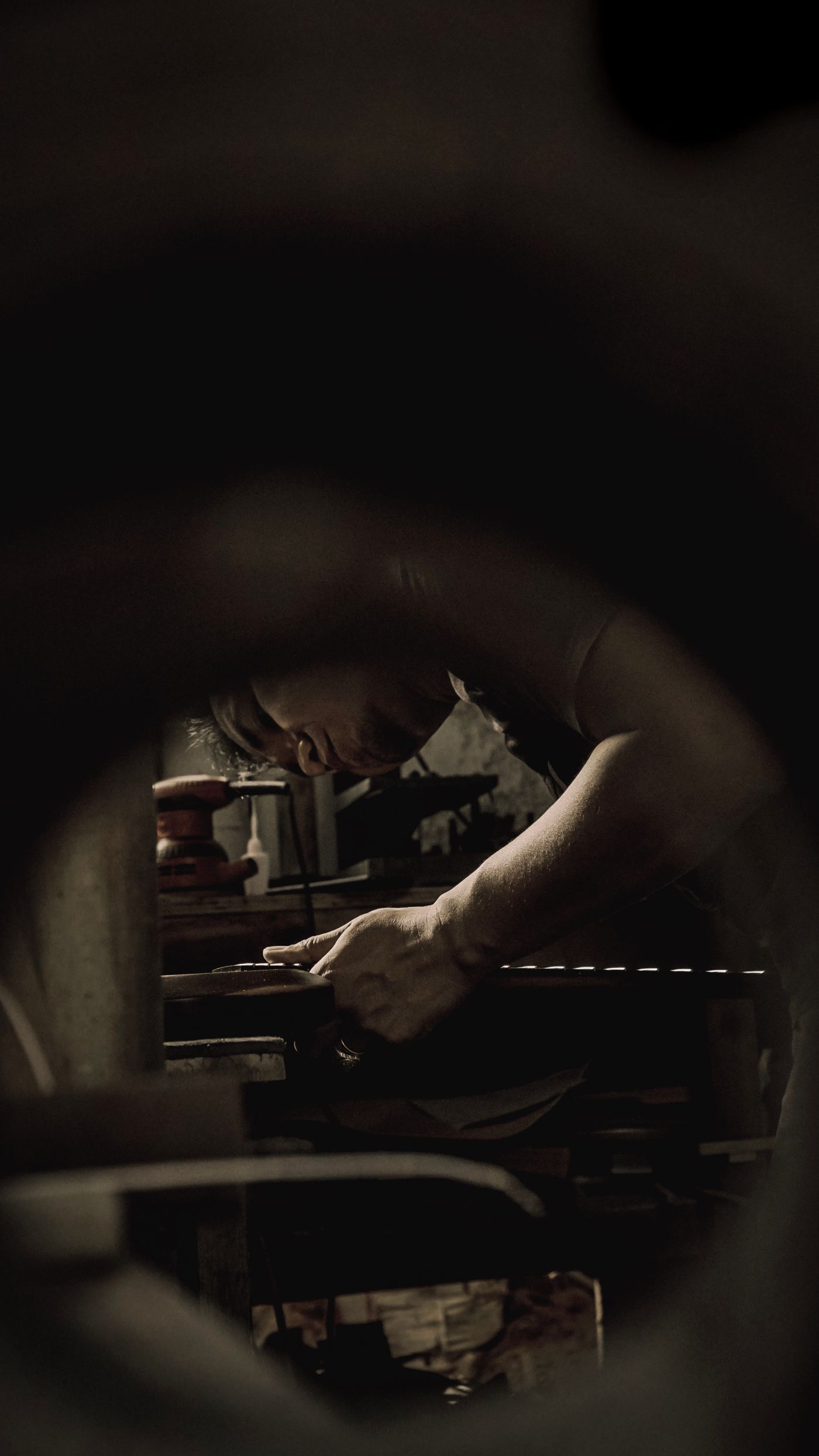 Craftsperson making a careful adjustment inside a piano